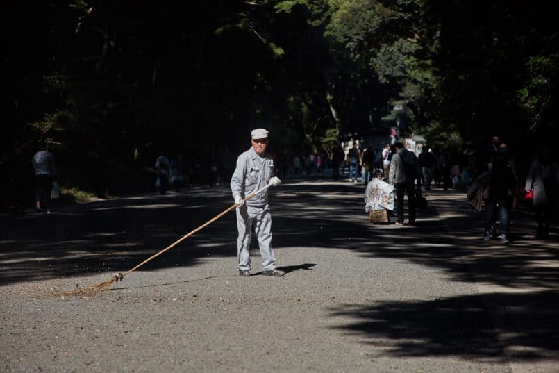 Man Sweeping Leaves